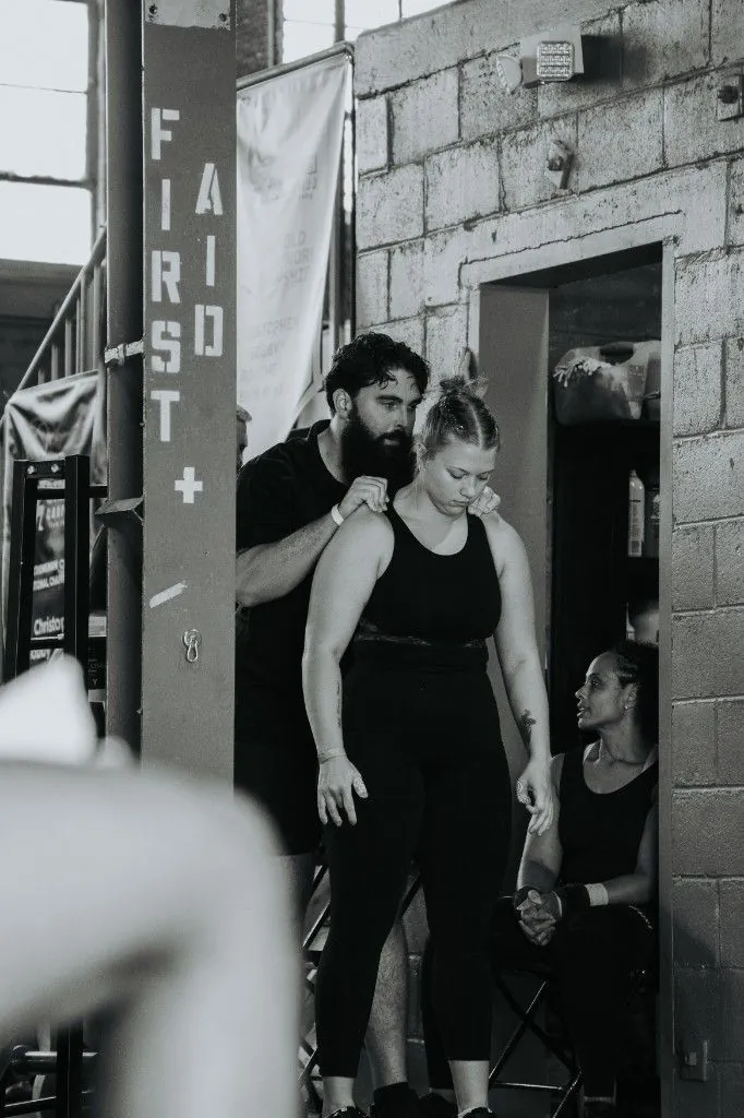 Sean with hand on Kylie's shoulder before her lift
